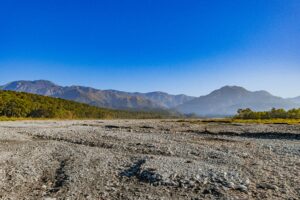 Breathtaking view of the Shivalik hills and rocky riverbed in Uttarakhand, India.